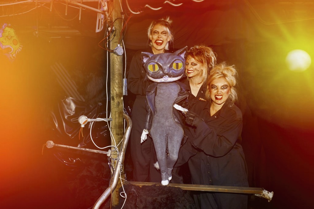 ALICE'S ADVENTURES UNDERGROUND. Samantha Sutherland, Abby Wain and Alice Bounce with The Cheshire Cat. Photo by Jason Joyce