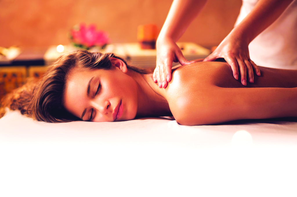 Young woman relaxing during back massage at the spa.