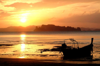 a beach in thailand with a sunset