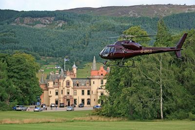 A helicopter landing outside exclusive use property, Aldourie Castle