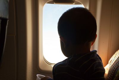 Little boy looking out the window