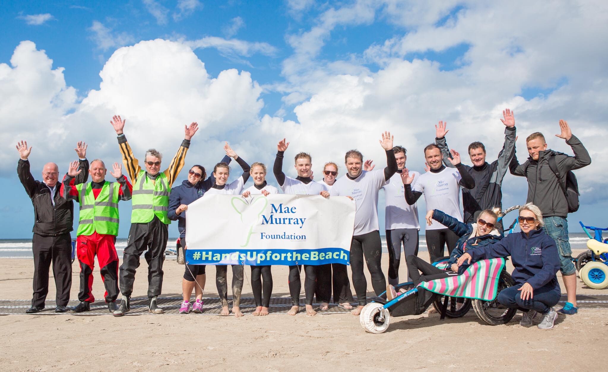 Group of inclusive beach users celebrate mae murray foundation inclusive beach in Portstewart