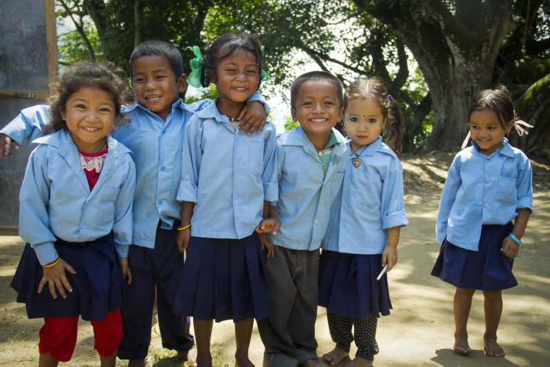 First grade students are playing in front of their class at a primary school in Melamchi in Sindhuapalchowk district. The primary school is situated on a hill in Nepalthok, in the town of Melamchi in Sindhuplachowk. In order to reach the school, students climb the rough hill, every single day. They walk miles to go to school, as they live in surrounding towns and the only way to reach it is to walk. The dust roads leading to the school are narrow and cannot fit vehicles. In addition to that, the potential cut-off roads and landslides which occur during the monsoon season make it harder for children to reach school. Save the Children has supported the government run primary school to open again and reinstate its classes by training teachers and providing the school with teaching materials.