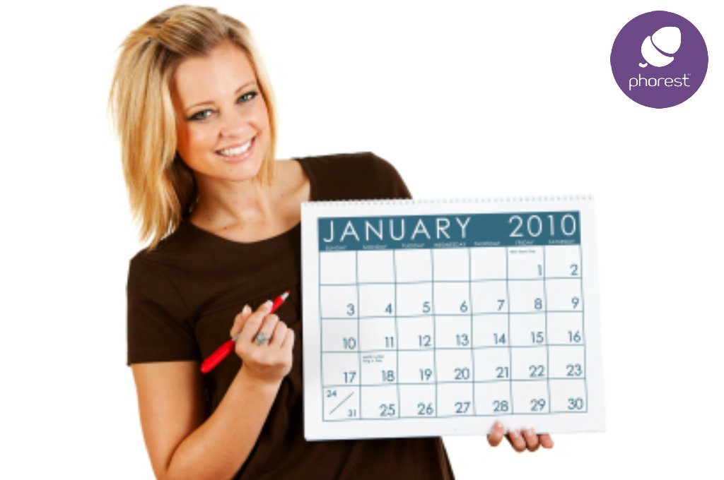 Woman holding January 2010 calendar