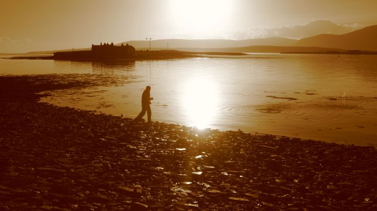 Richard skimming stones in Stromness