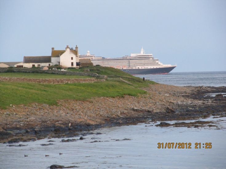 Queen Elizabeth passing Brough in South Ronaldsay