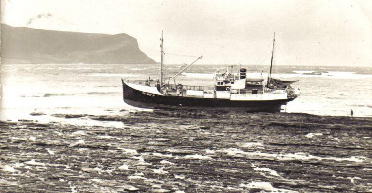 Fishing boat on the rocks