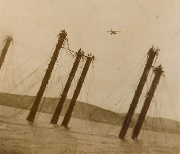 Biplane over German fleet salvage work