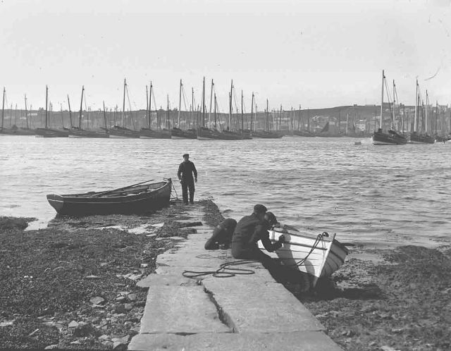 Men painting boat on one of the Holms
