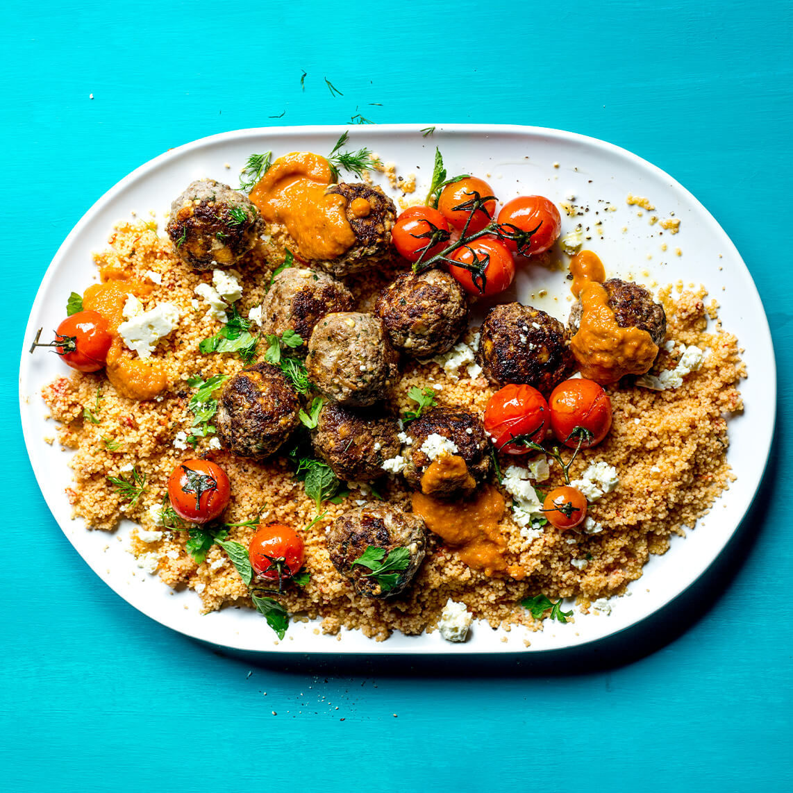 Lemony meatballs with feta on tomato couscous