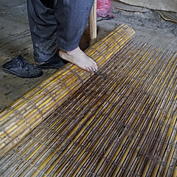Rolling felt in a reed mat
