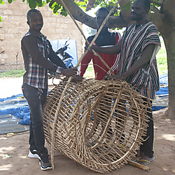Ewe fishermen with a basketry fish trap
