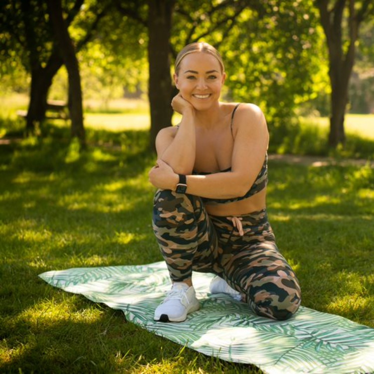 Photograph: Alice Liveing on a yoga mat outdoors