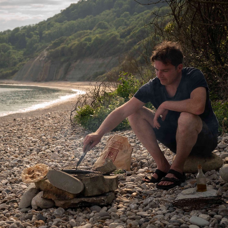 Photograph: Gill Meller cooking on a campfire
