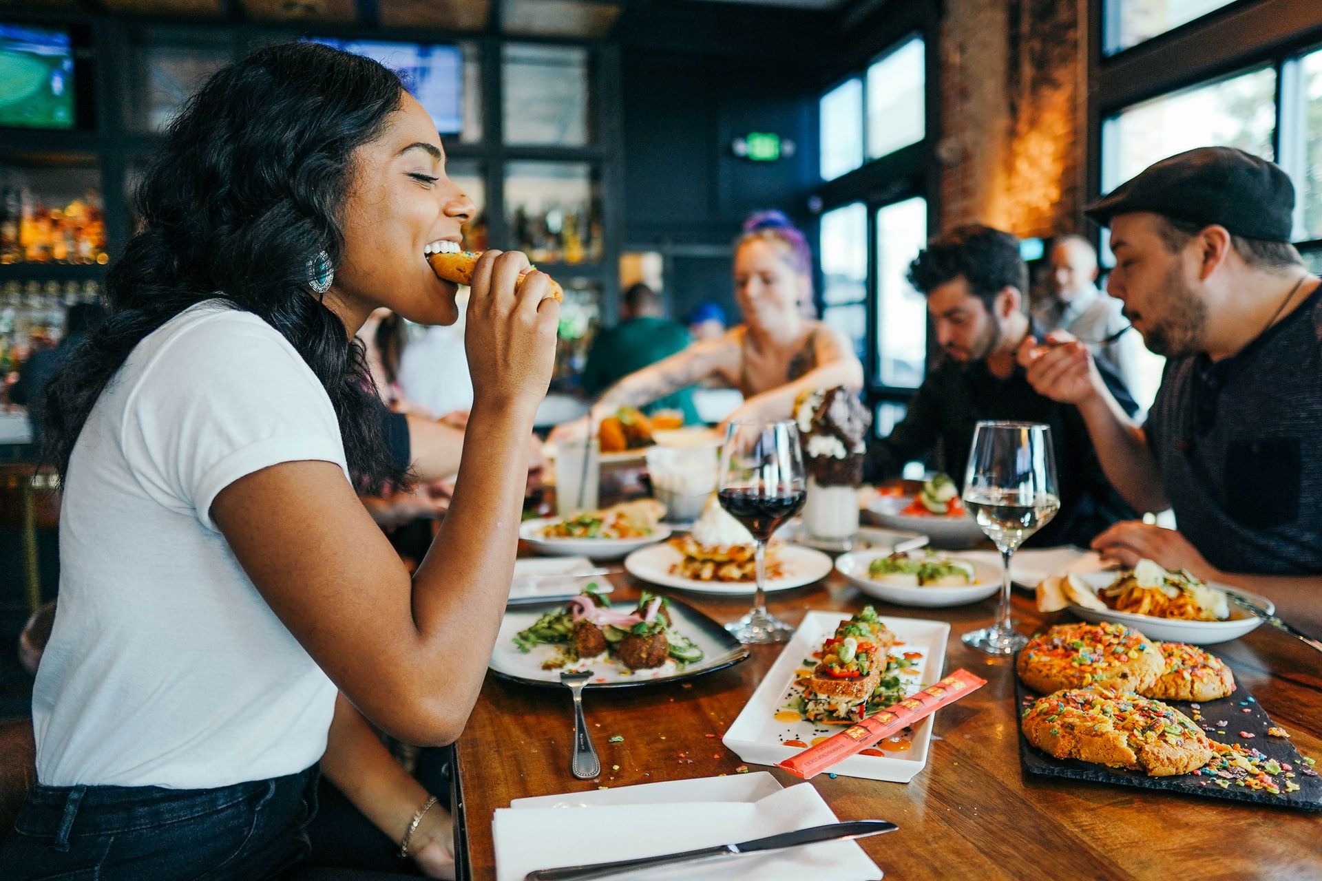 Person eating healthy food at a restaurant.