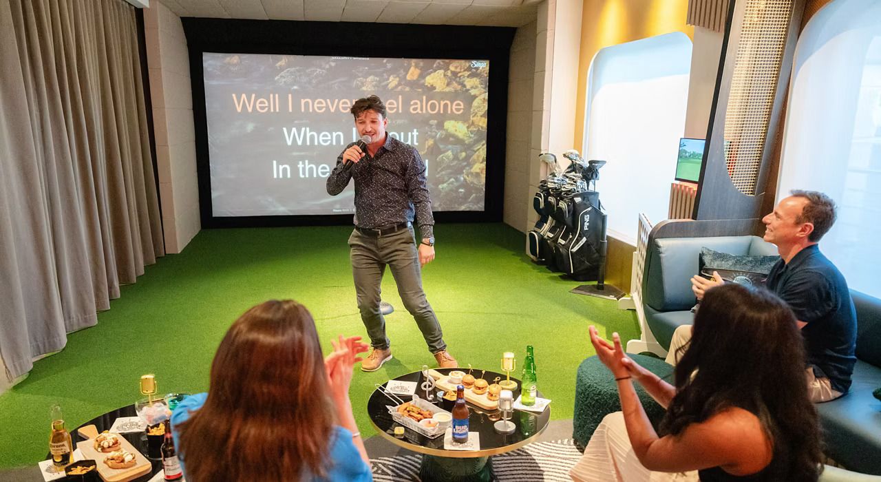 A group singing karaoke at a private karaoke room aboard Celebrity Cruises cruise ship. Singa