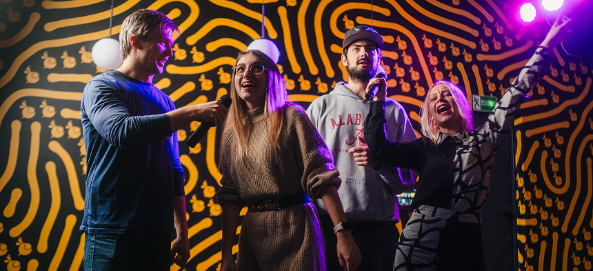 People singing karaoke at Arcade Bee, Krakow.