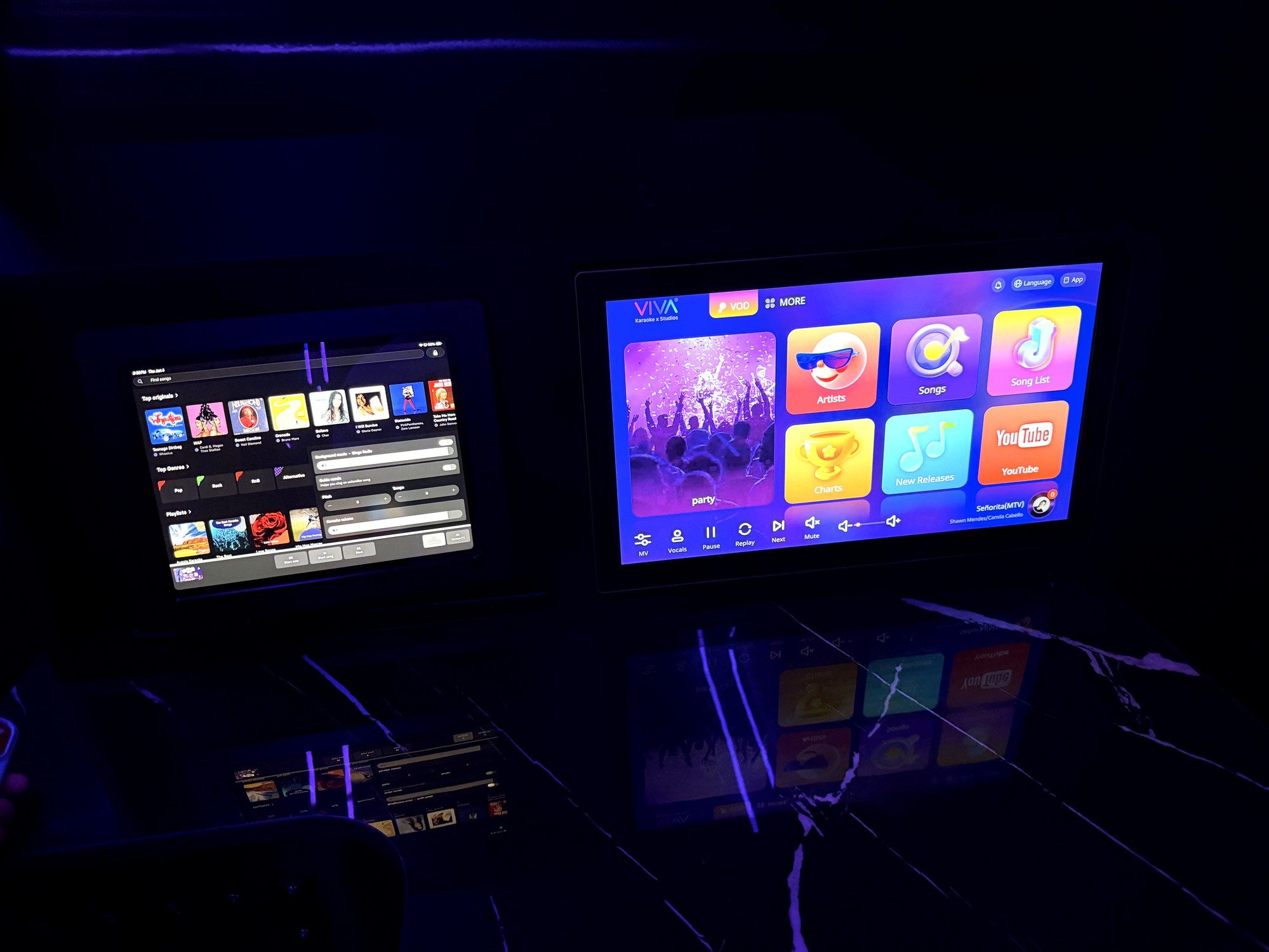 Two tablets running the VIVA karaoke interface side by side, showing artists, songs and search.
