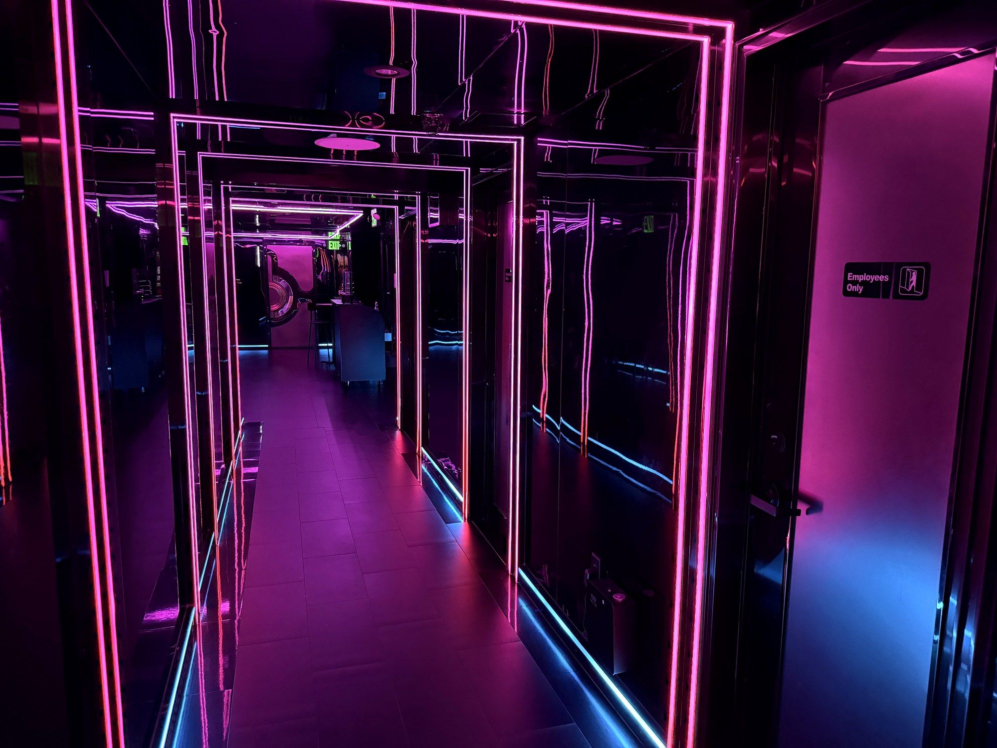 Neon-lit infinity mirror corridor inside VIVA Karaoke.