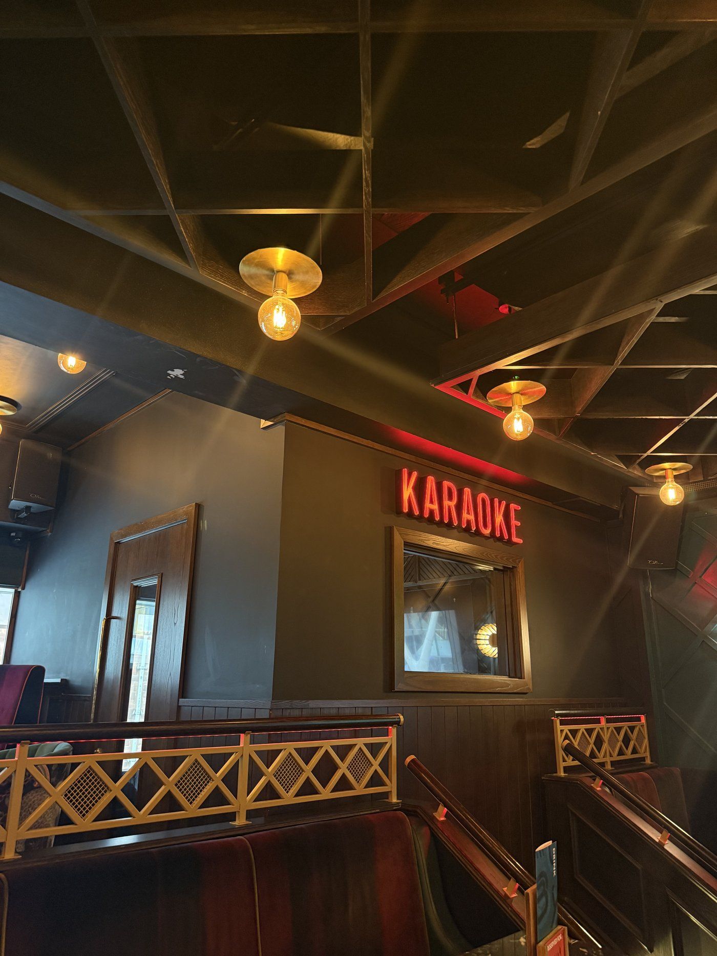 The 'KARAOKE' neon sign marking the entrance to Manahatta's upstairs karaoke rooms