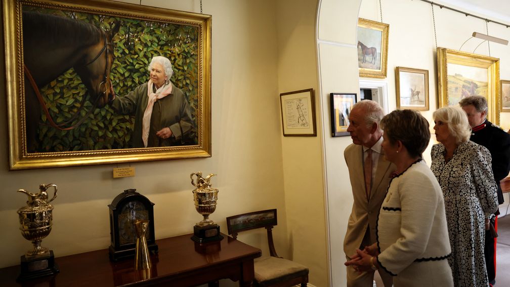 The King and Queen admire a painting of Queen Elizabeth II