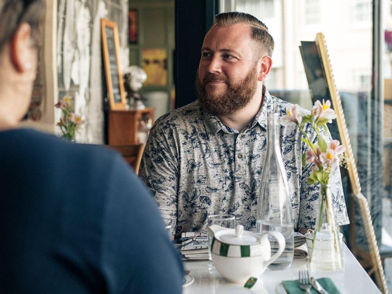 Dean at a table in a restaurant