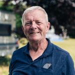 David smiling with caravan in the background