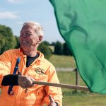 Man waving racing flag