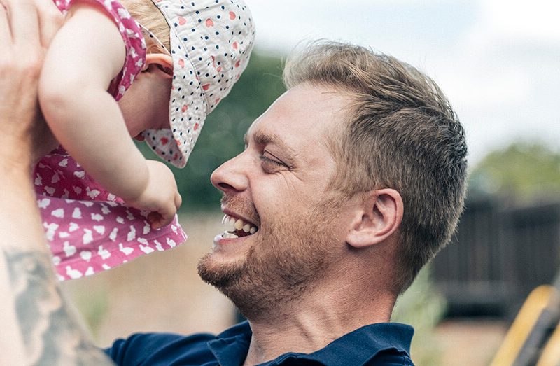 Andrew lifting up his kid
