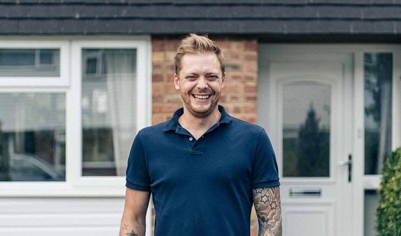 Andrew smiling at front door