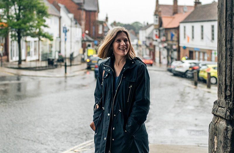 Woman smiling while walking on high street