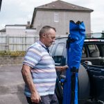 Kevin putting fishing rods in the car