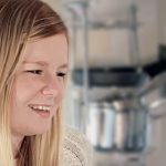 Profile of girl sat in kitchen