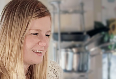 Profile of girl sat in kitchen