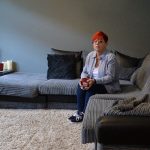Sue sitting on her sofa