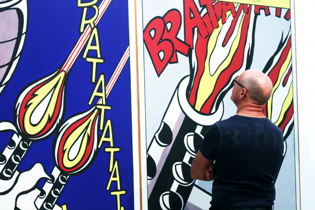 man is looking at work by Roy Lichtenstein