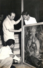 Sukarno, Dullah (crouched), and Gapoer examining a painting at Merdeka Palace, 1950s.
