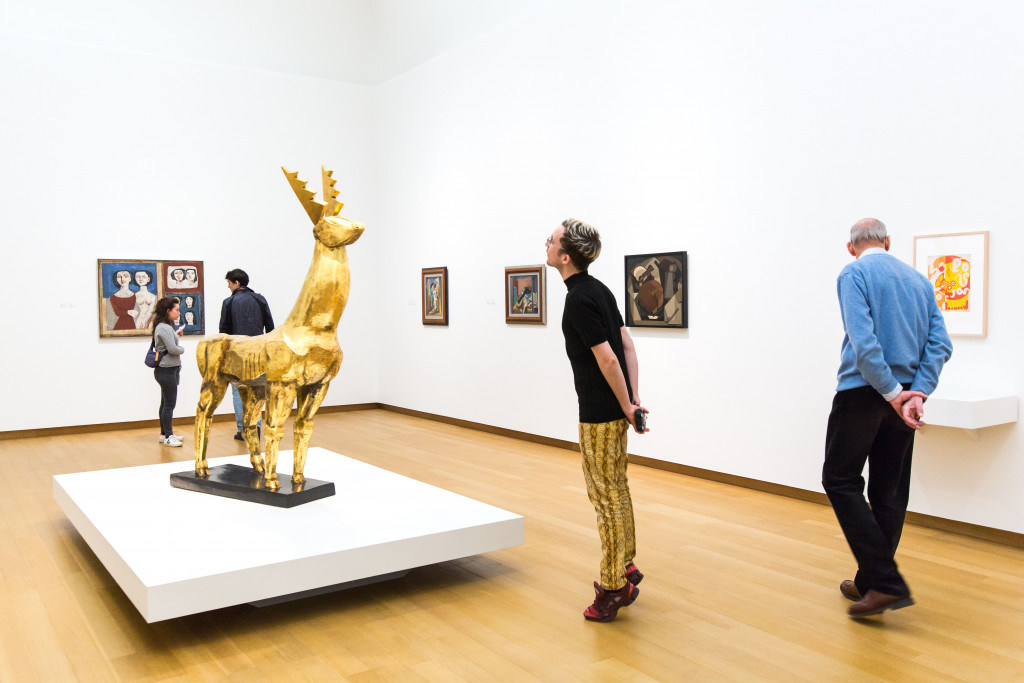 Visitors at the opening. From left to right, works by: Campigli; Zadkine; Severini (2 x);  Rivera, all gifts of P.A. Regnault to the Dutch State, on loan to the Stedelijk Museum, 1953; and Goncharova. Photo: Maarten Nauw.