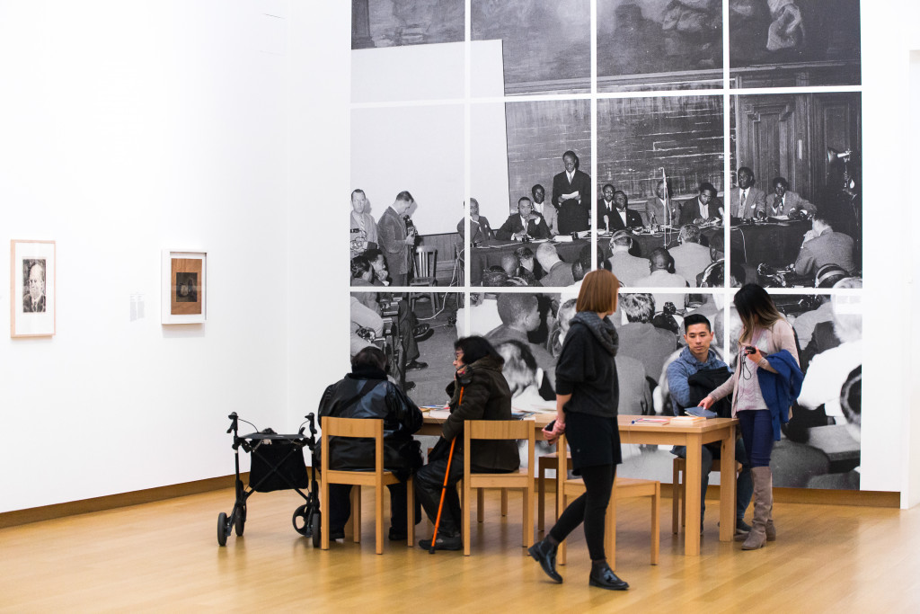 Visitors in front of a photo of the First Congress of Black Writers and Artists in Paris, © Roger-Viollet. Lecturer: Alioune Diop, (co-)founder of the magazine Présence africaine. At the table, 3rd from right: Aimé Césaire. Photo: Maarten Nauw.