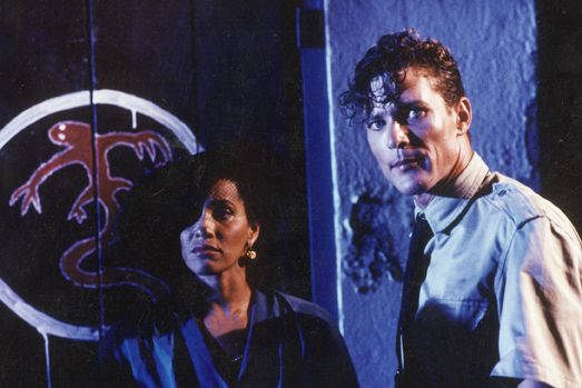 a woman and a man looking at the camera