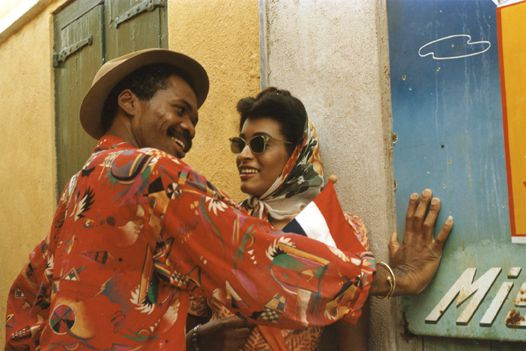 a woman and a man who are talking to each other and laughing