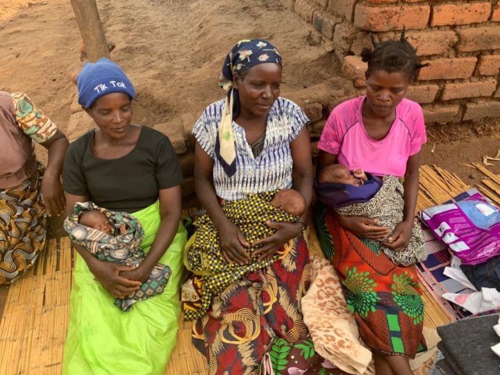 3 women sitting with triplets in their arms