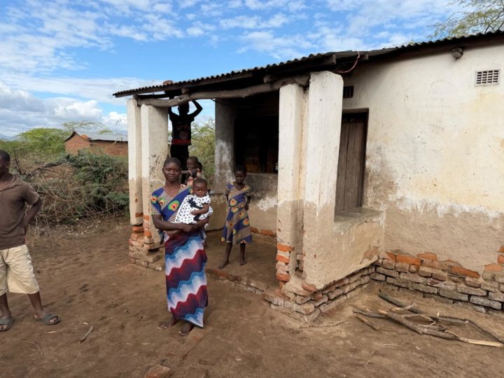 A family outside their house in a Malawian village