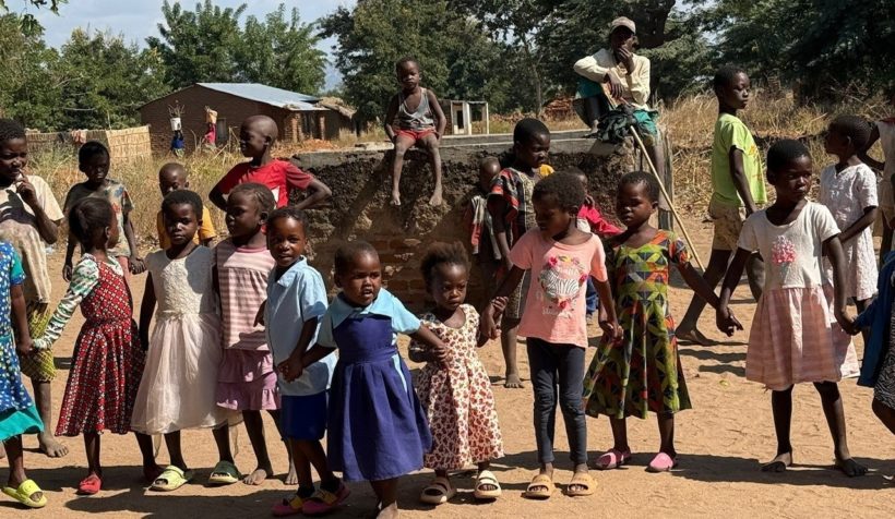 children in Malawi holding hands
