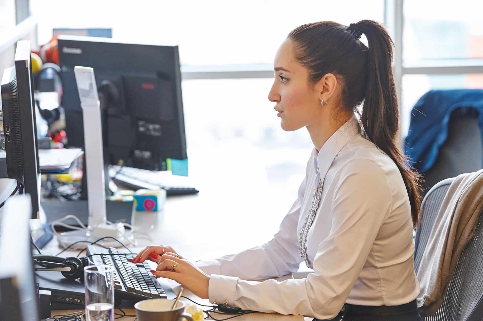 rapariga de cabelo atado a trabalhar ao computador