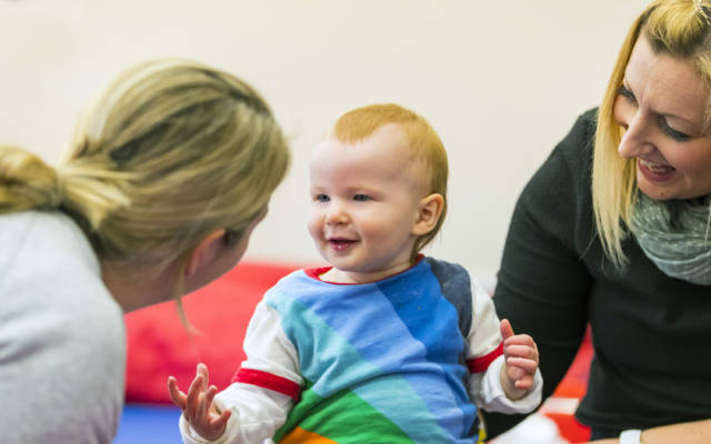 Young child talking with caregivers