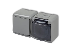 JUNIOR IP54 Wyłącznik pojedynczy z gniazdem pojedynczym z uziemieniem (klapka dymna: bez przesłon) popielaty0WGHH-1d KARLIK