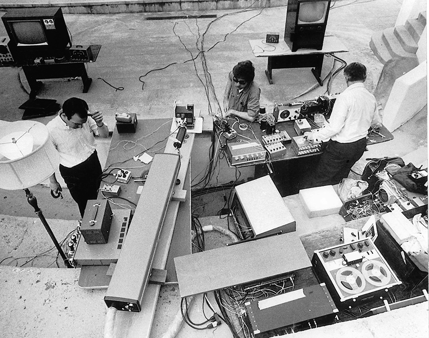 Lowell Cross (left), Eugene Turitz (center) and David Tudor (right) setting up for the first laser light show to use x-y scanning, Mills College, Oakland, CA, May 9, 1969