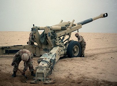 U.S. Marine artillerymen with their 155 mm howitzer gun