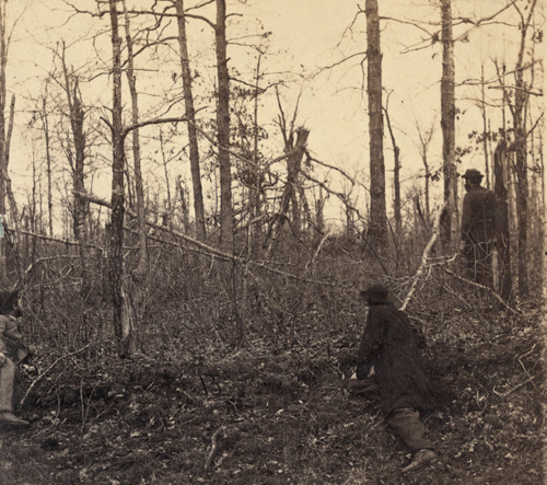 Three men surveying the effects of artillery fire after the Battle of Chancellorsville. It was near this location where Stonewall Jackson was mistakenly shot by his own men